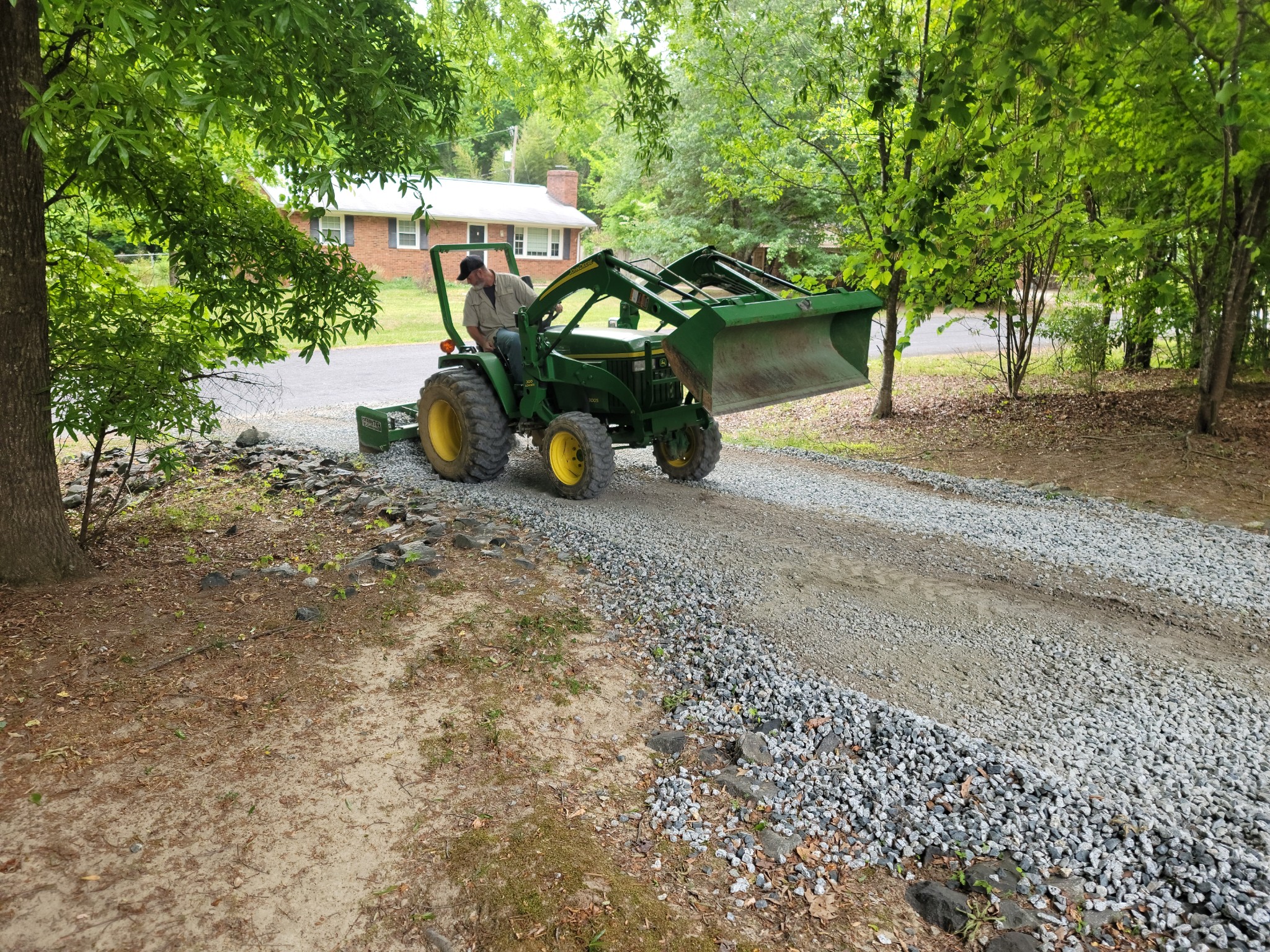 Removing excess gravel from ruts in order to repair base and respread gravel.