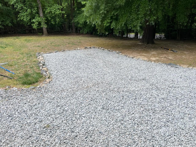Stone-bordered gravel pad